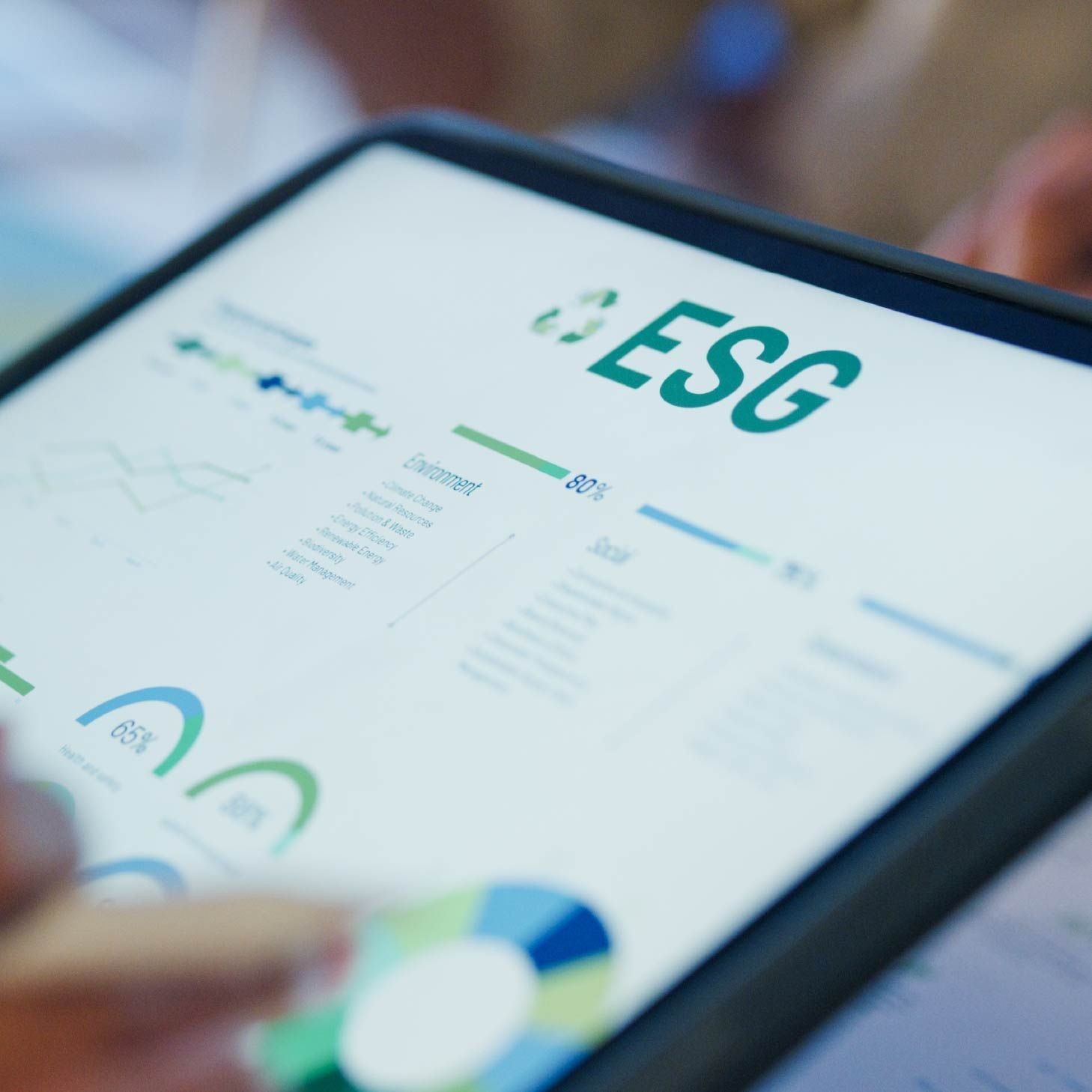 Tablet displaying ESG data with charts and graphs.